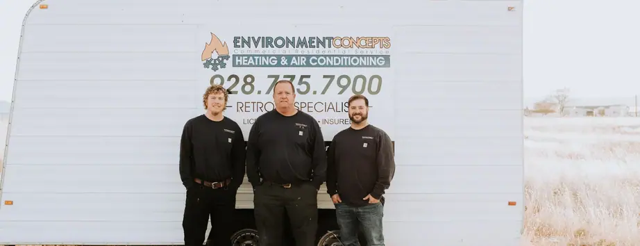 Three Environment Concepts technicians standing in front of their branded equipment trailer