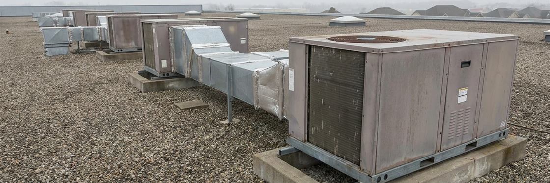 Packaged rooftop air-conditioning units in a row on a large commercial building.