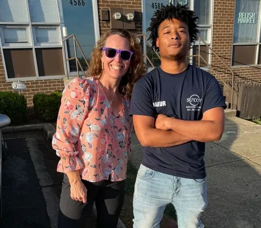 Sarah Gonzales standing outside with a Su&rsquo;Coy team member in front of a row of shopfronts