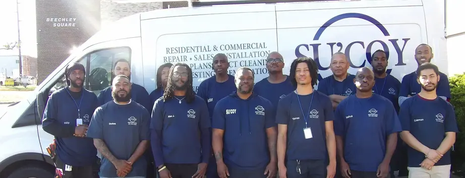The Su&rsquo;Coy HVAC crew of fourteen standing in front of a branded service van