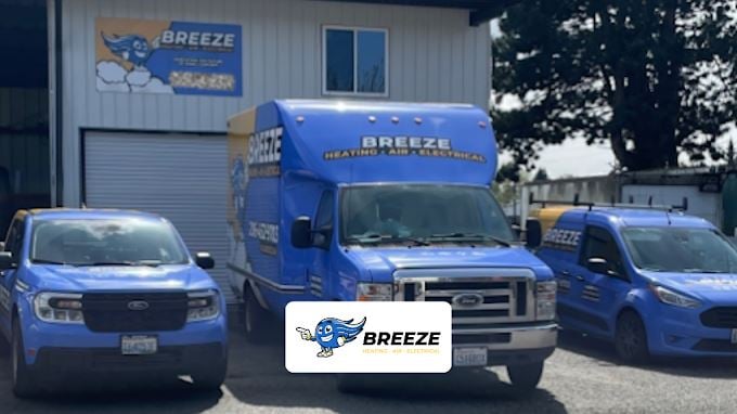 Breeze Heating, Air and Electrical van wraps in blue and yellow, carrying the mascot, phone number and domain