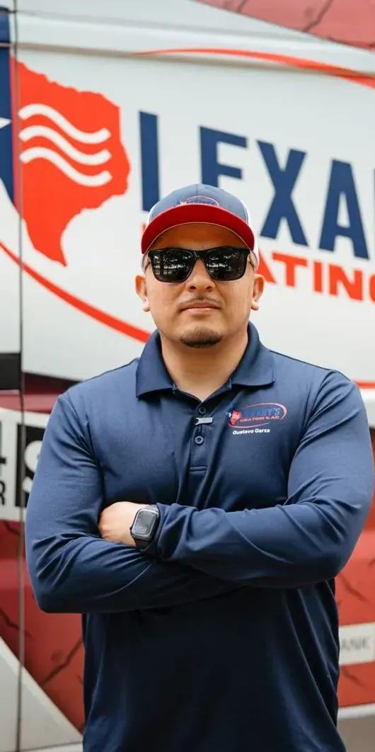 A Lexany&rsquo;s Heating & AC technician standing with arms crossed in front of a branded service truck