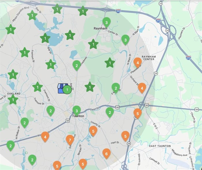 A local search ranking grid across a service area, with green pins at the centre and orange pins at the edges